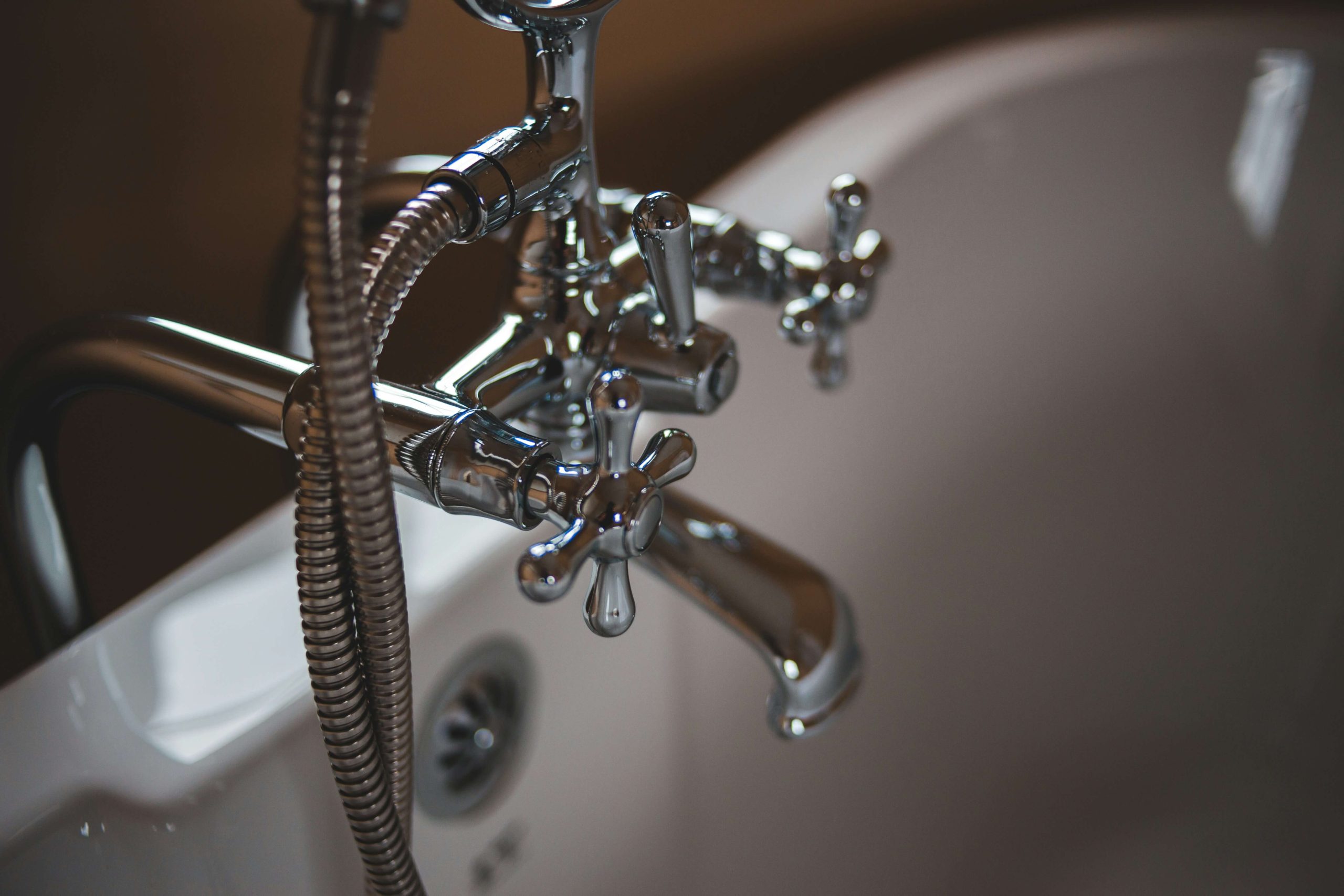 A bath with chrome tap and shower attachment